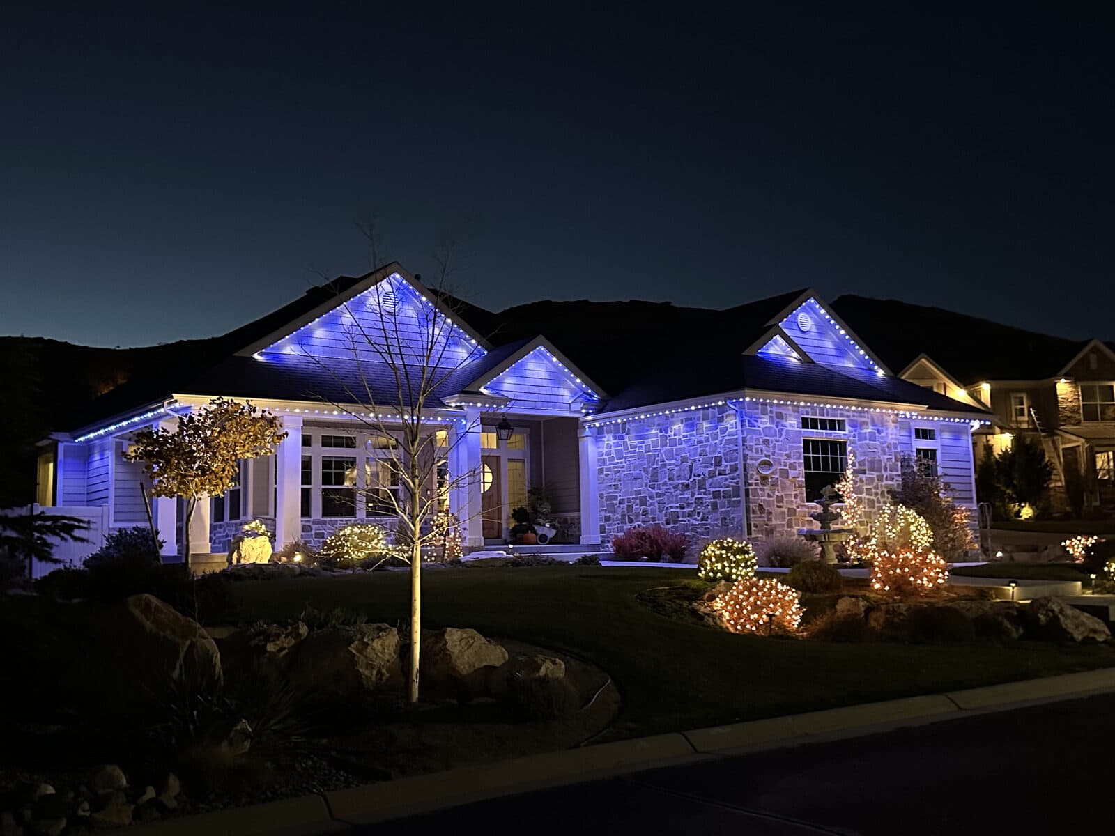 Real Alta permanent install in holiday blue on a stone rambler